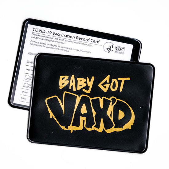 black vaccine card protector with gold foil design saying "Baby Got Vax'd"